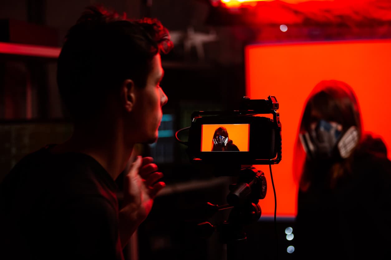 A backstage of shooting of young woman in the protective mask