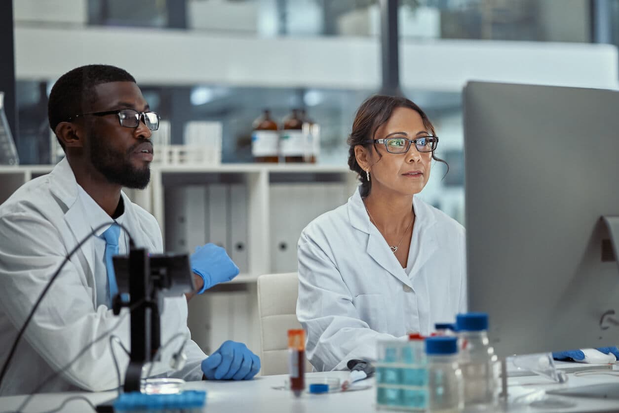 Shot of two scientists working together on a computer in a lab