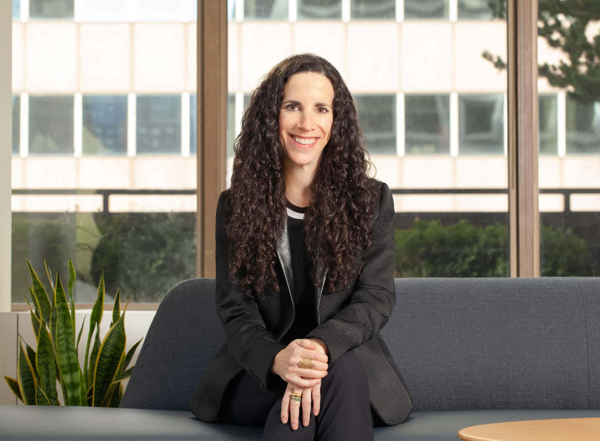 Headshot of Jill sitting in front of a window