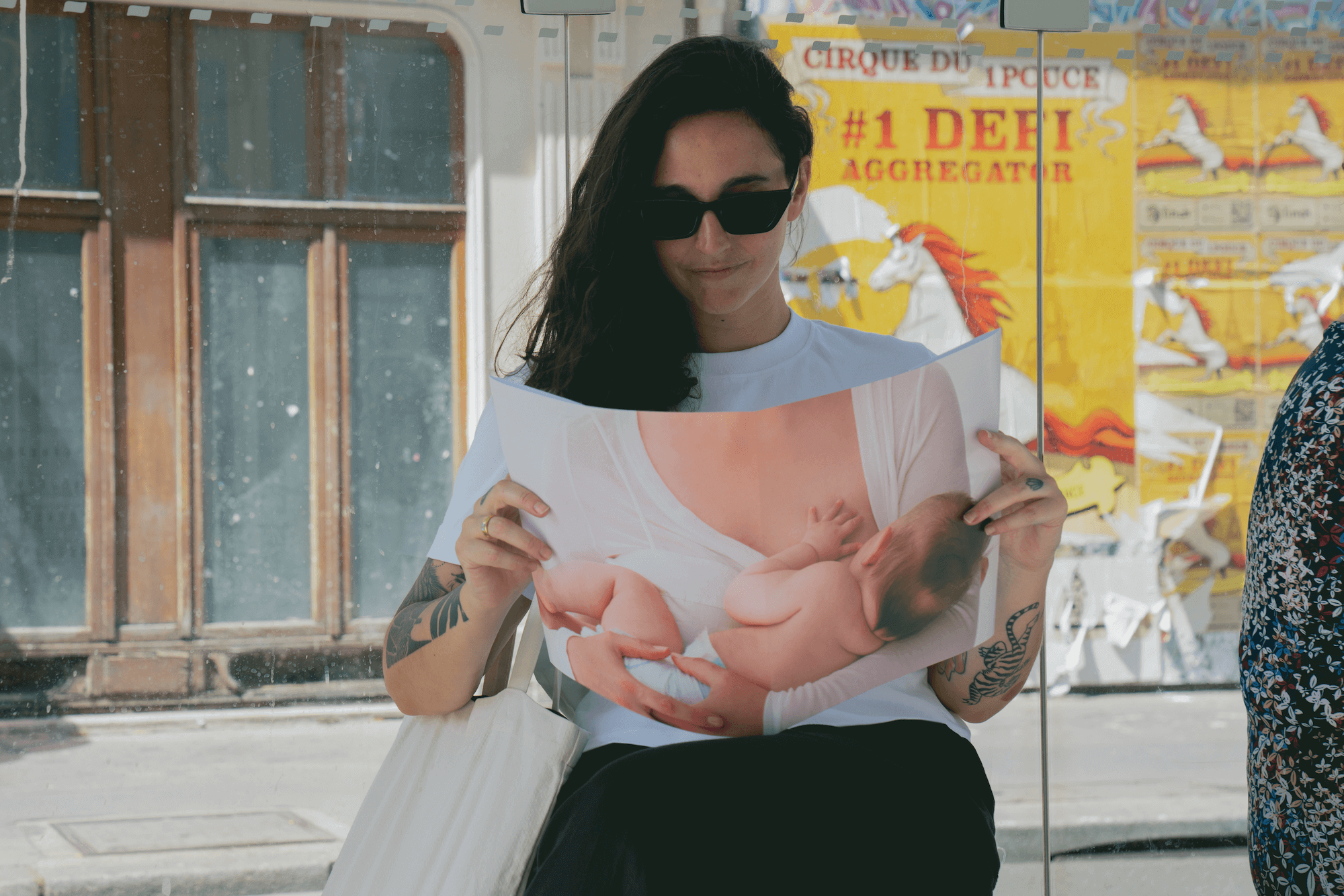 Women in public with open page spread of breast feeding image