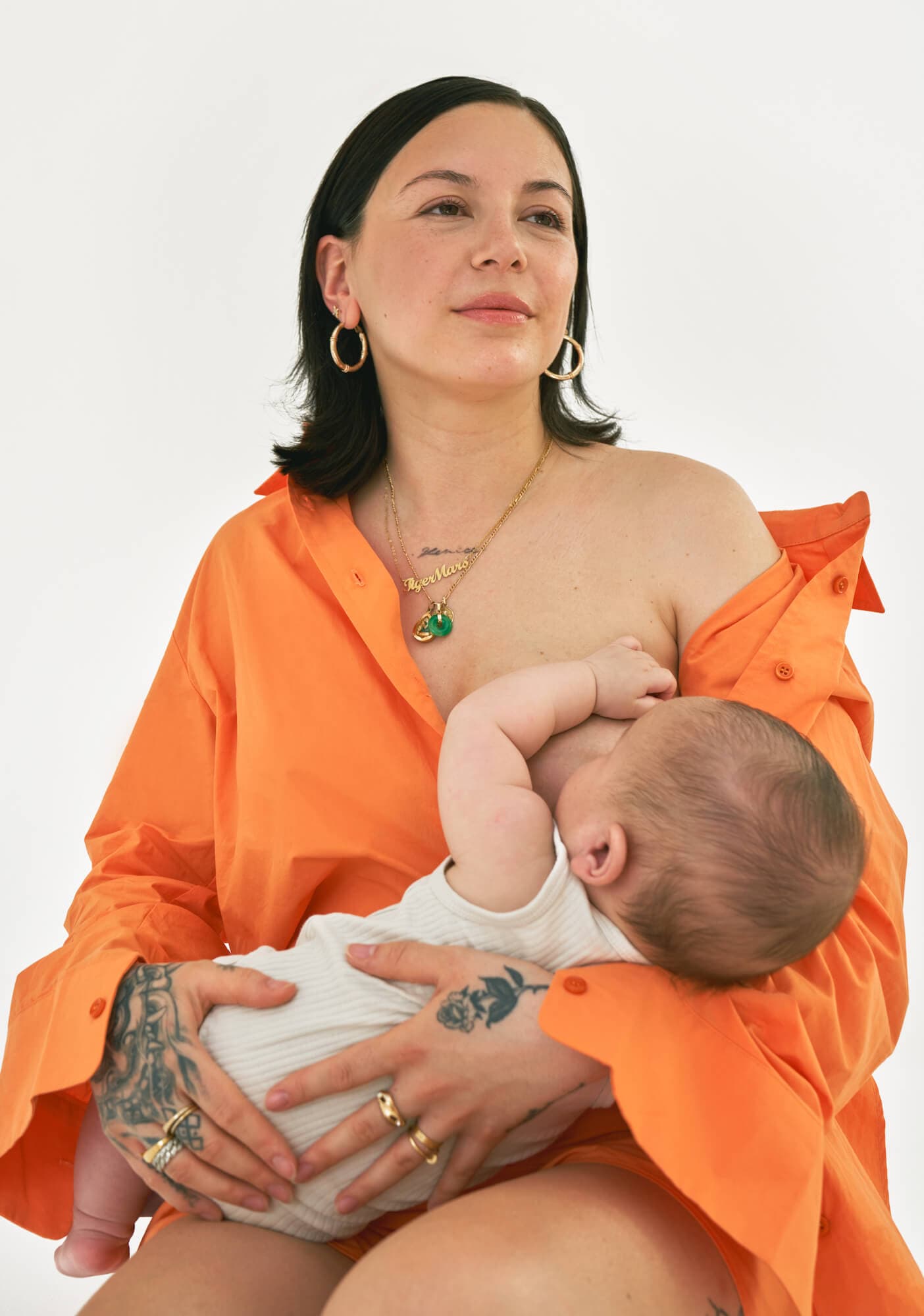 women breast feeding her child sitting down