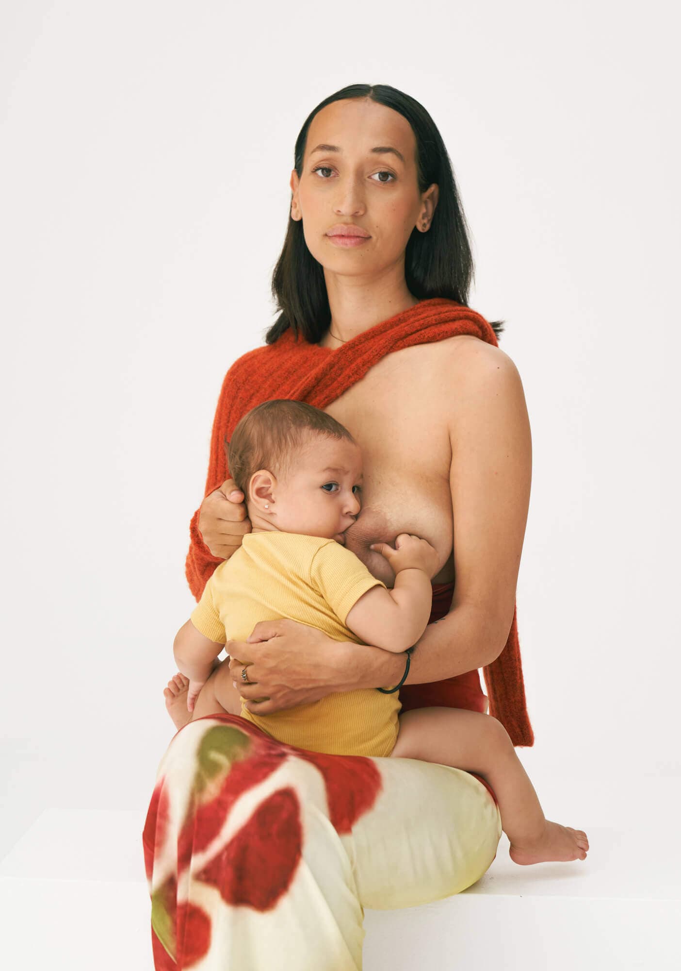 women breast feeding her child sitting down