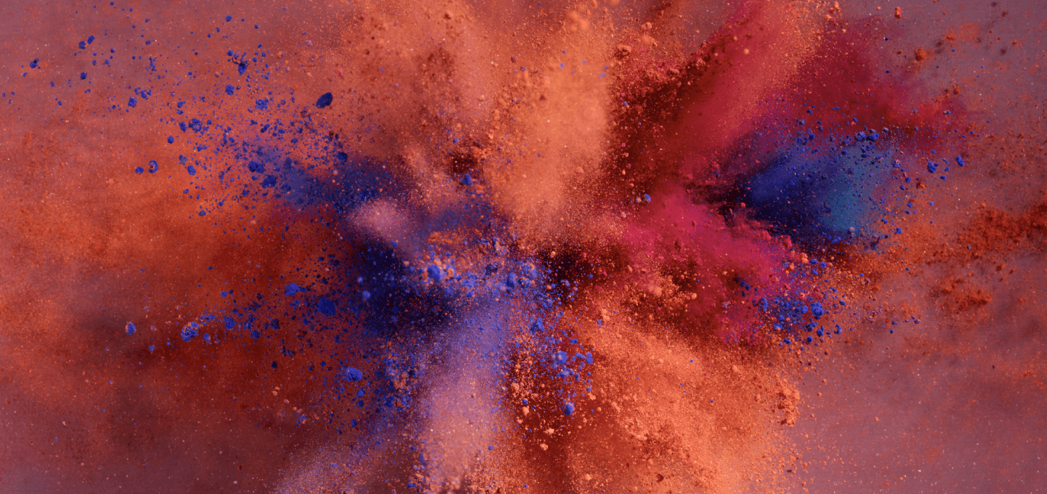 Multi-colored chalk splatter coming out in all directions towards the camera