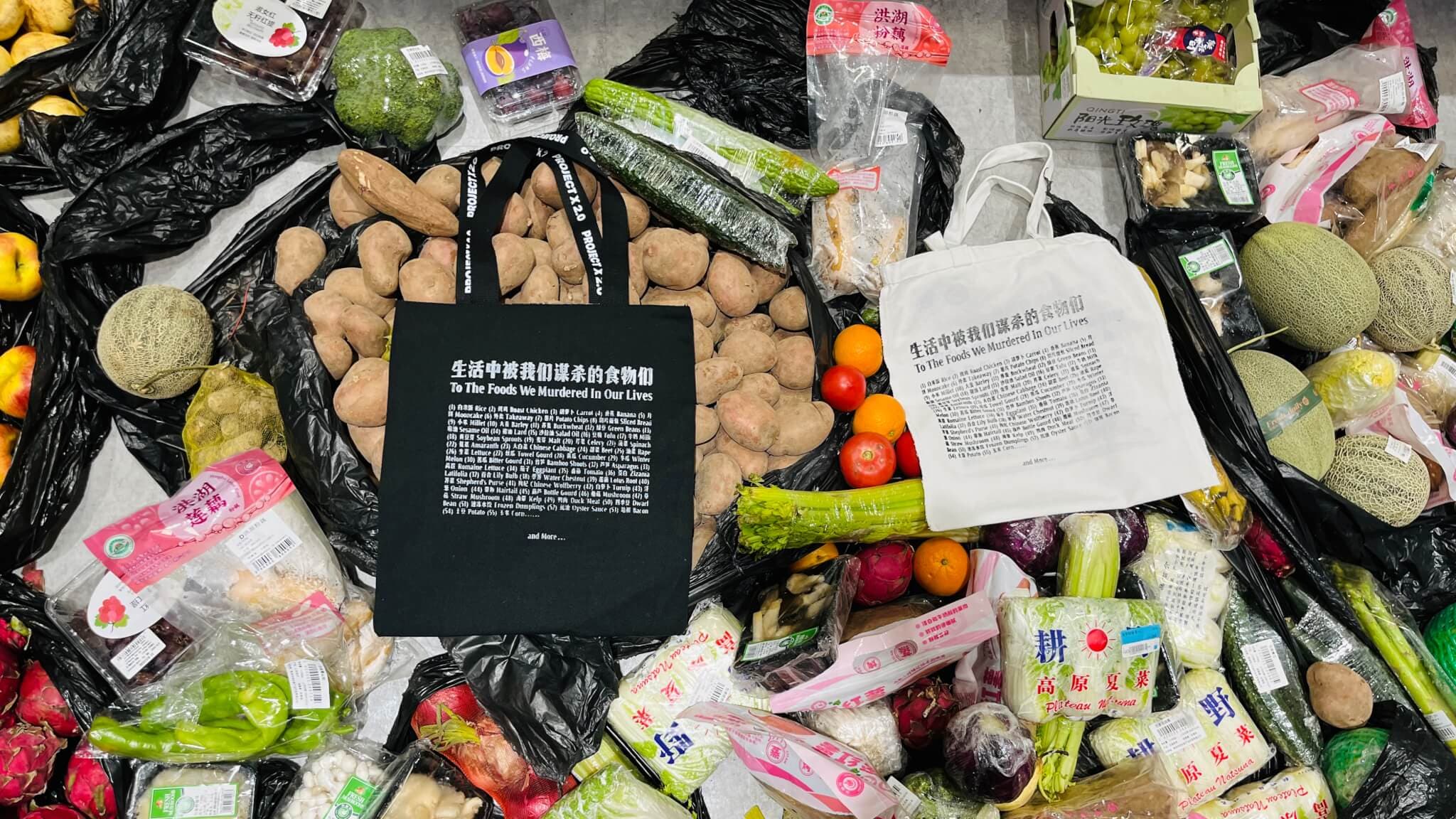 Image of wasted foods with two printed canvas tote bags sitting on top