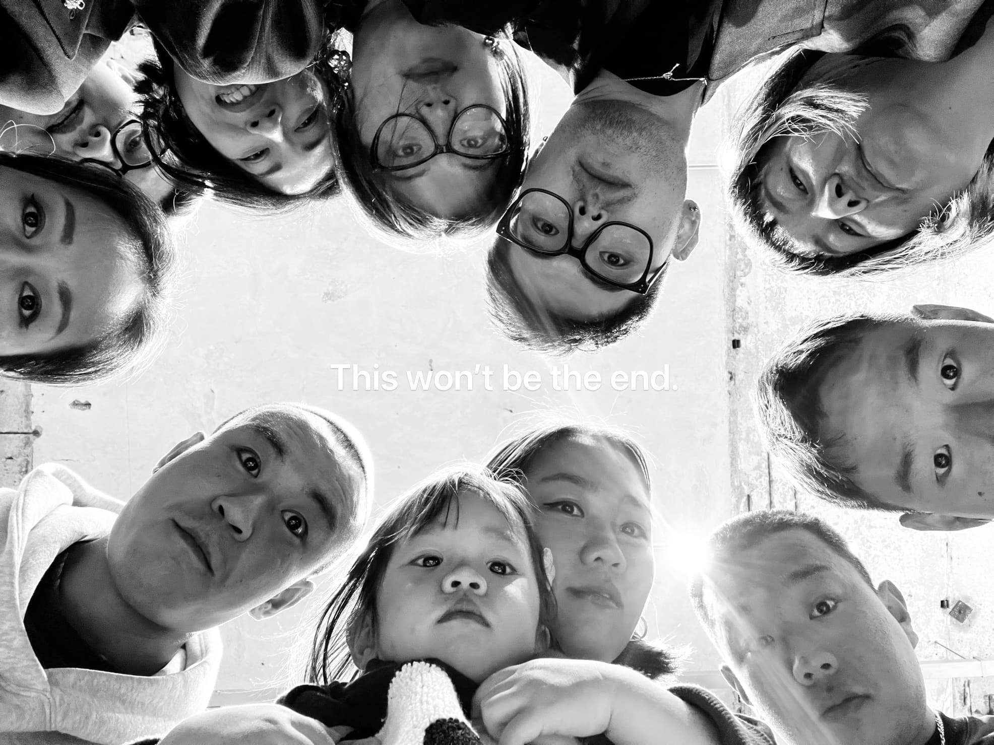 A group of Weber Shandwick employees stand in a circle, looking down. Text in the center reads: "This won't be the end."