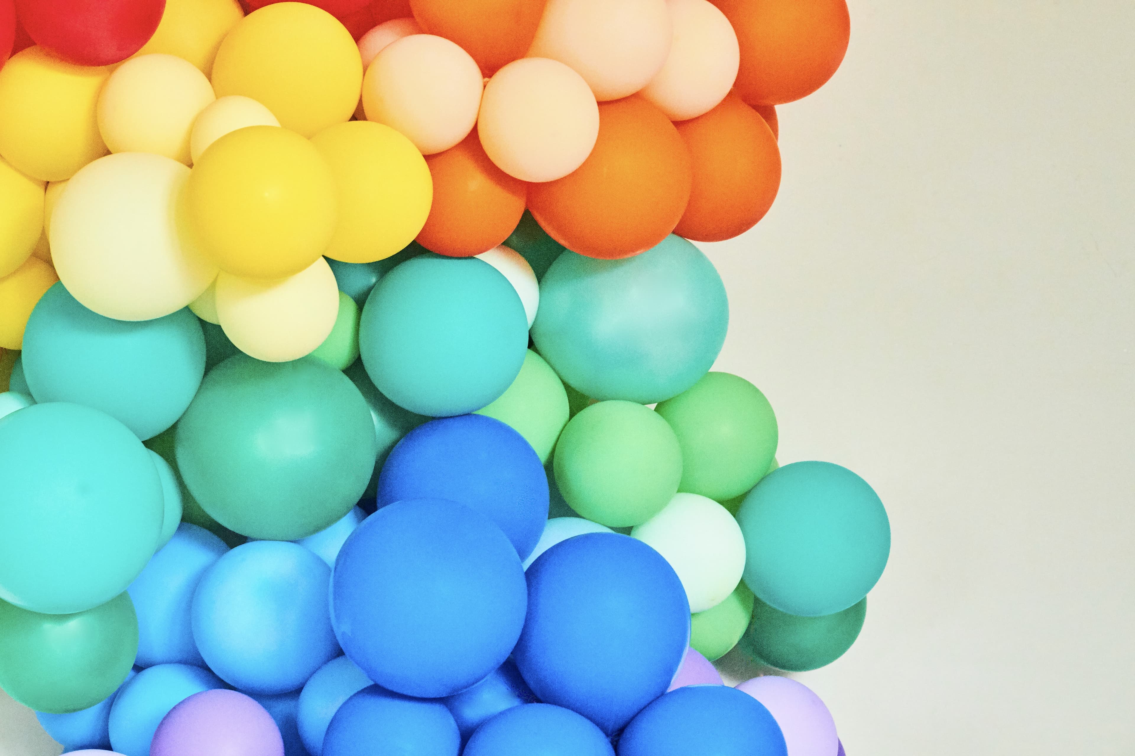 Different sizes of balloons in all the rainbow colors