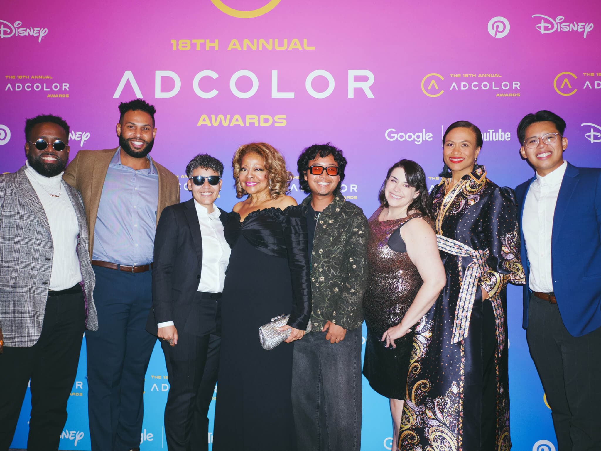 Image of 7 employees from The Weber Shandwick Collective onstage with ADCOLOR Honoree Judith Harison at the 18th Annual ADCOLOR Awards.