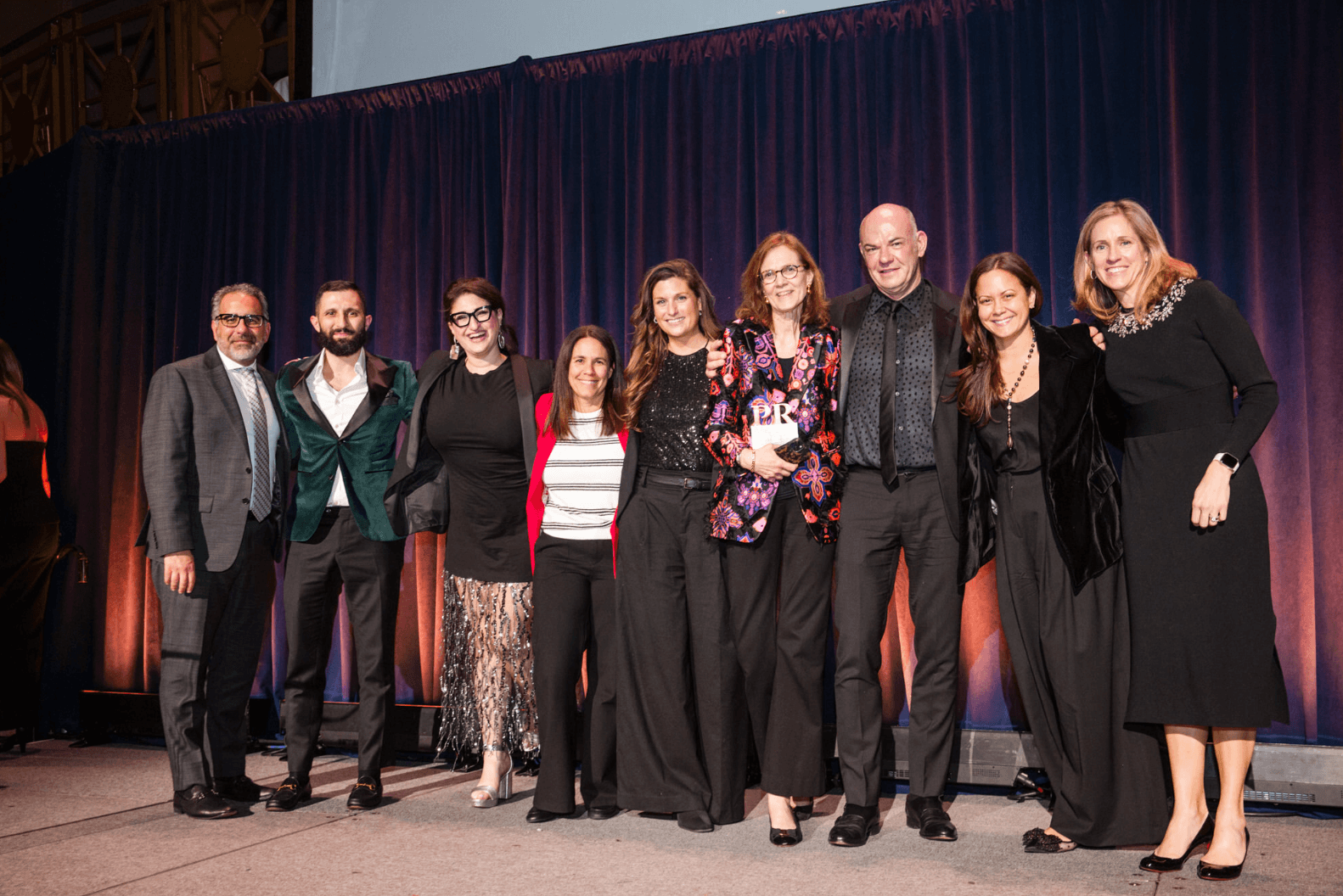Photo of 9 people standing on the stage at this year's PRWeek US Awards