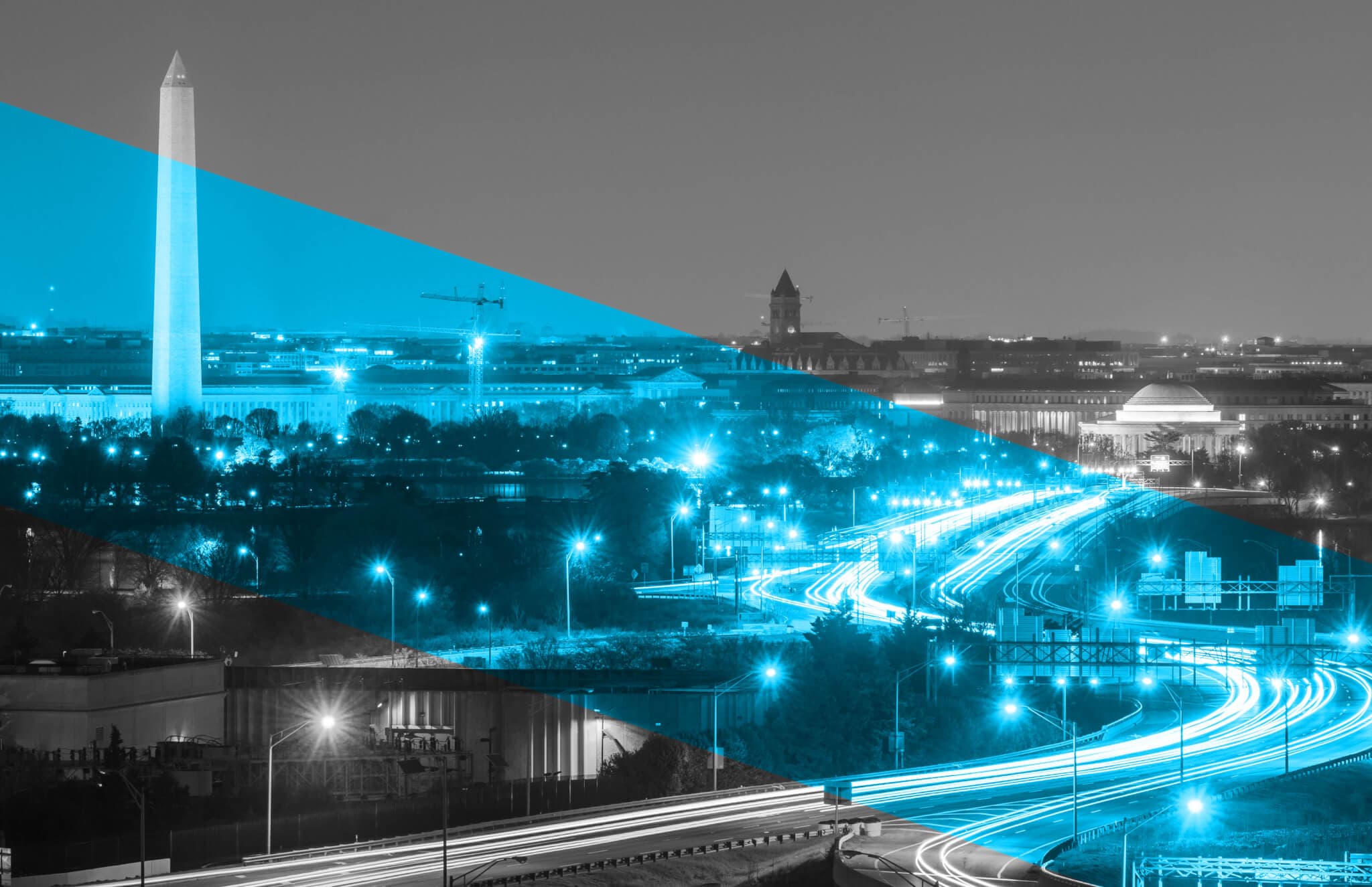 Image of Washington DC at night, with the Washington Monument visible in the upper lefthand corner
