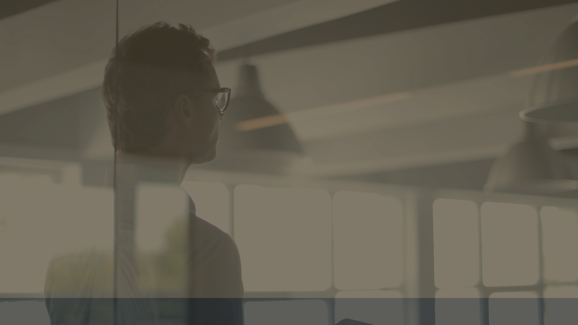 Image of a silhouette of a man looking through a window