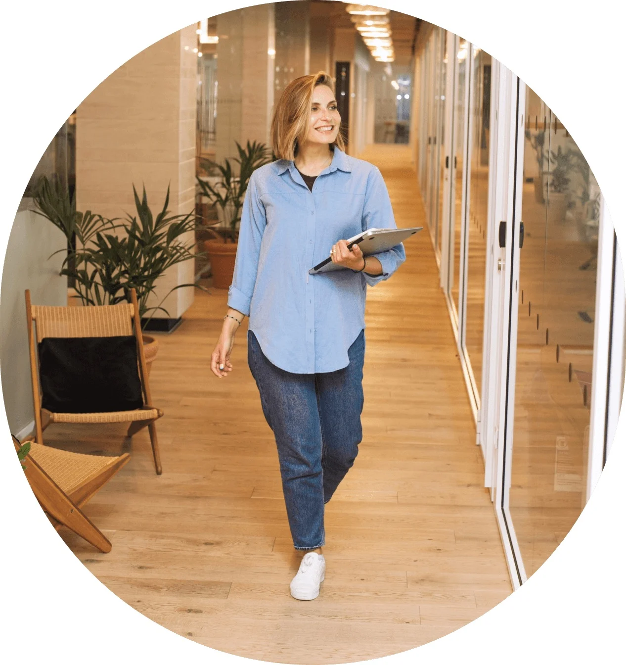 Weber Shandwick team member walking through an office with a tablet, representing individual talent and collective purpose