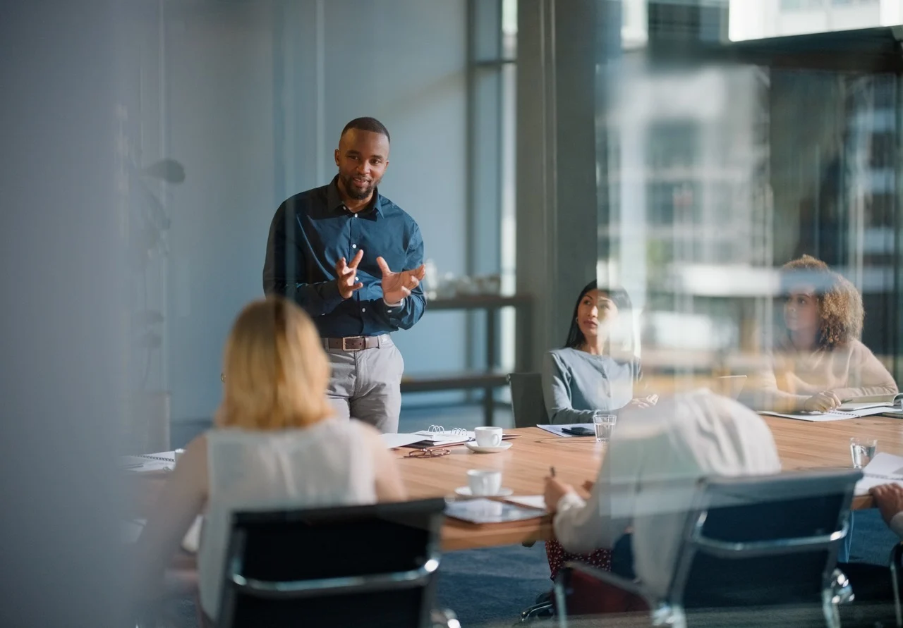 Advisor leading a discussion in a meeting, presenting public affairs strategy at the intersection of policy, business, and culture