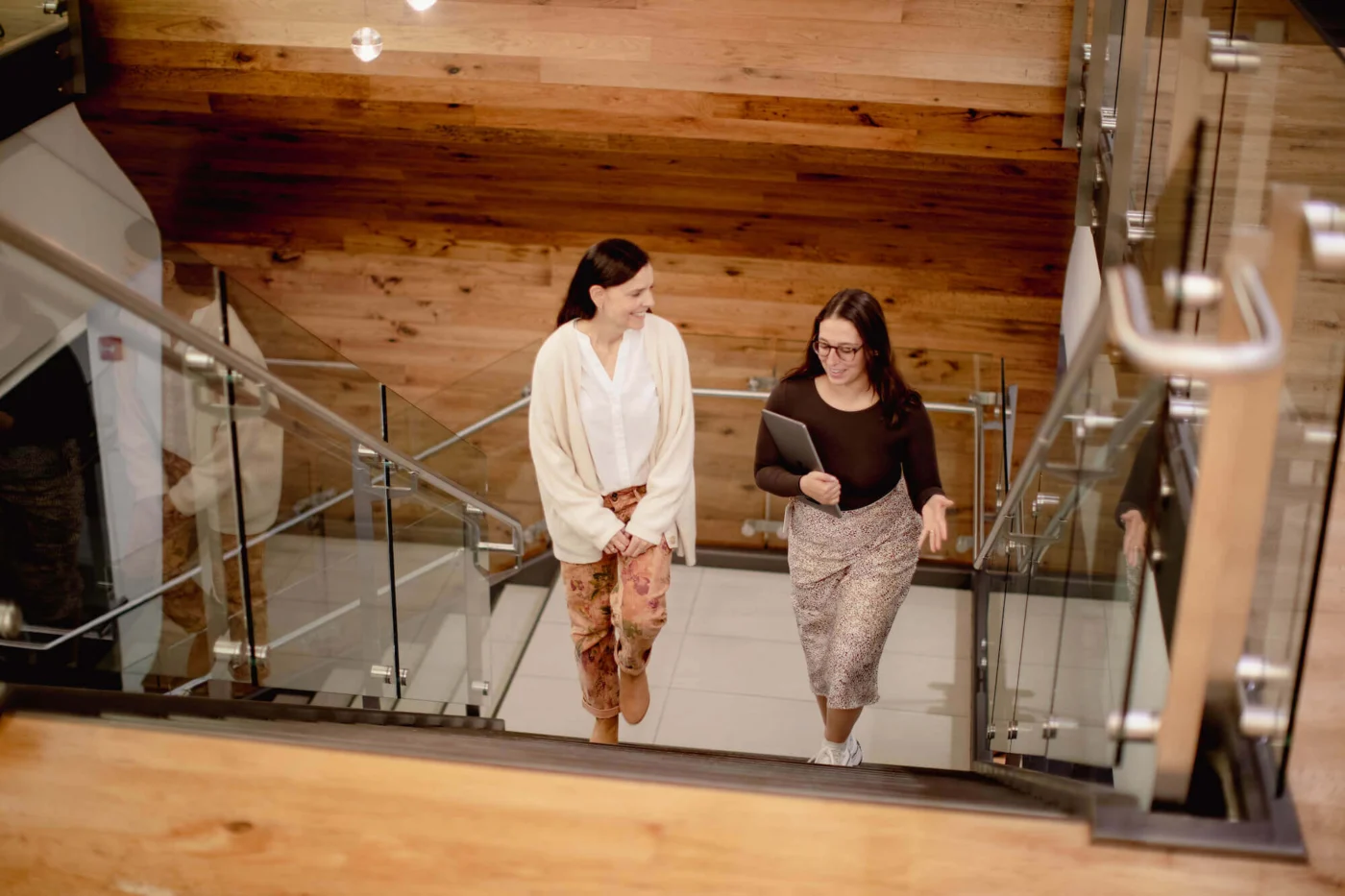 Weber Shandwick team members walking up staircase in Chicago office, collaborating in modern workspace in Illinois