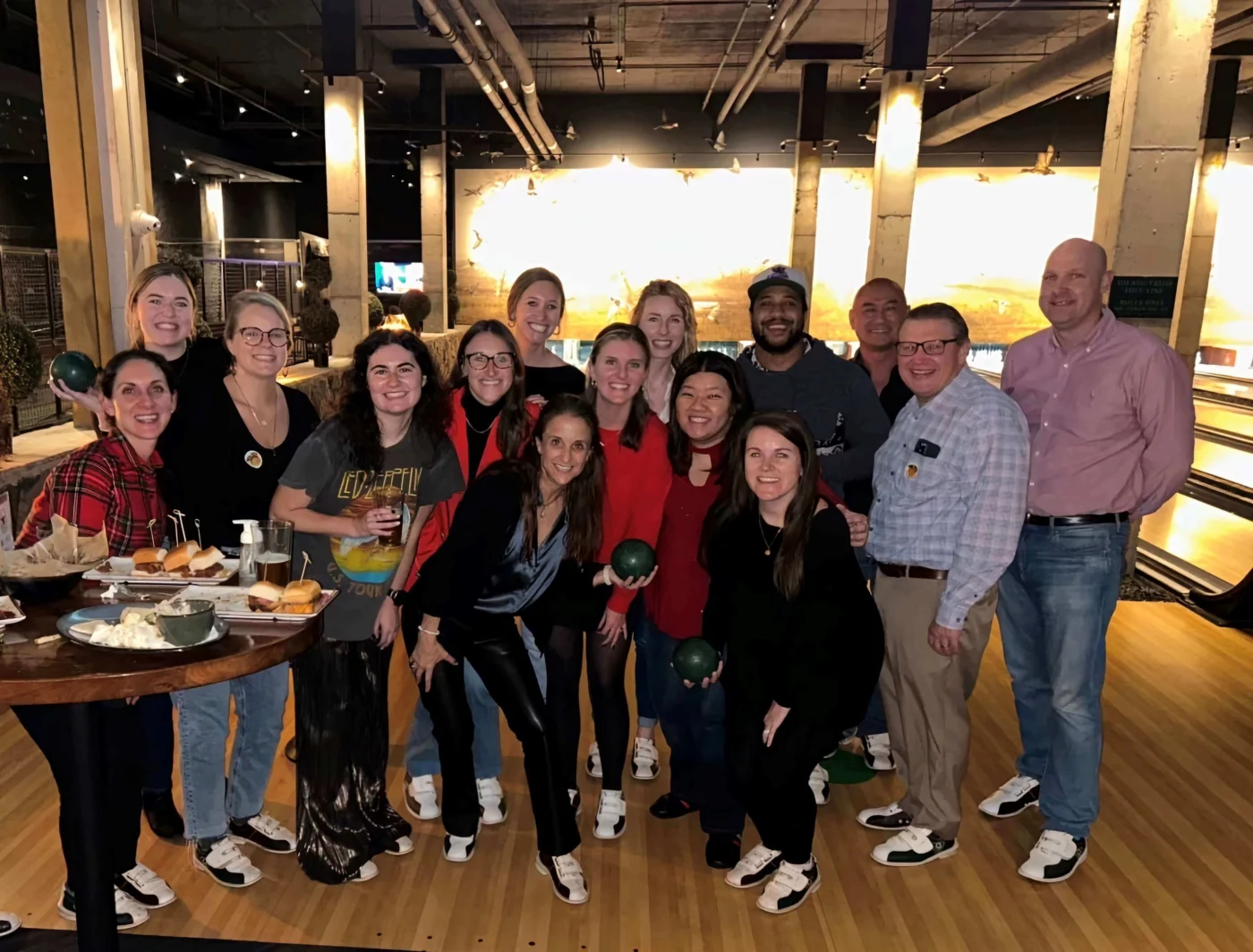 Weber Shandwick Atlanta team at a bowling social event, reflecting a collaborative culture and strong community within the West Midtown office