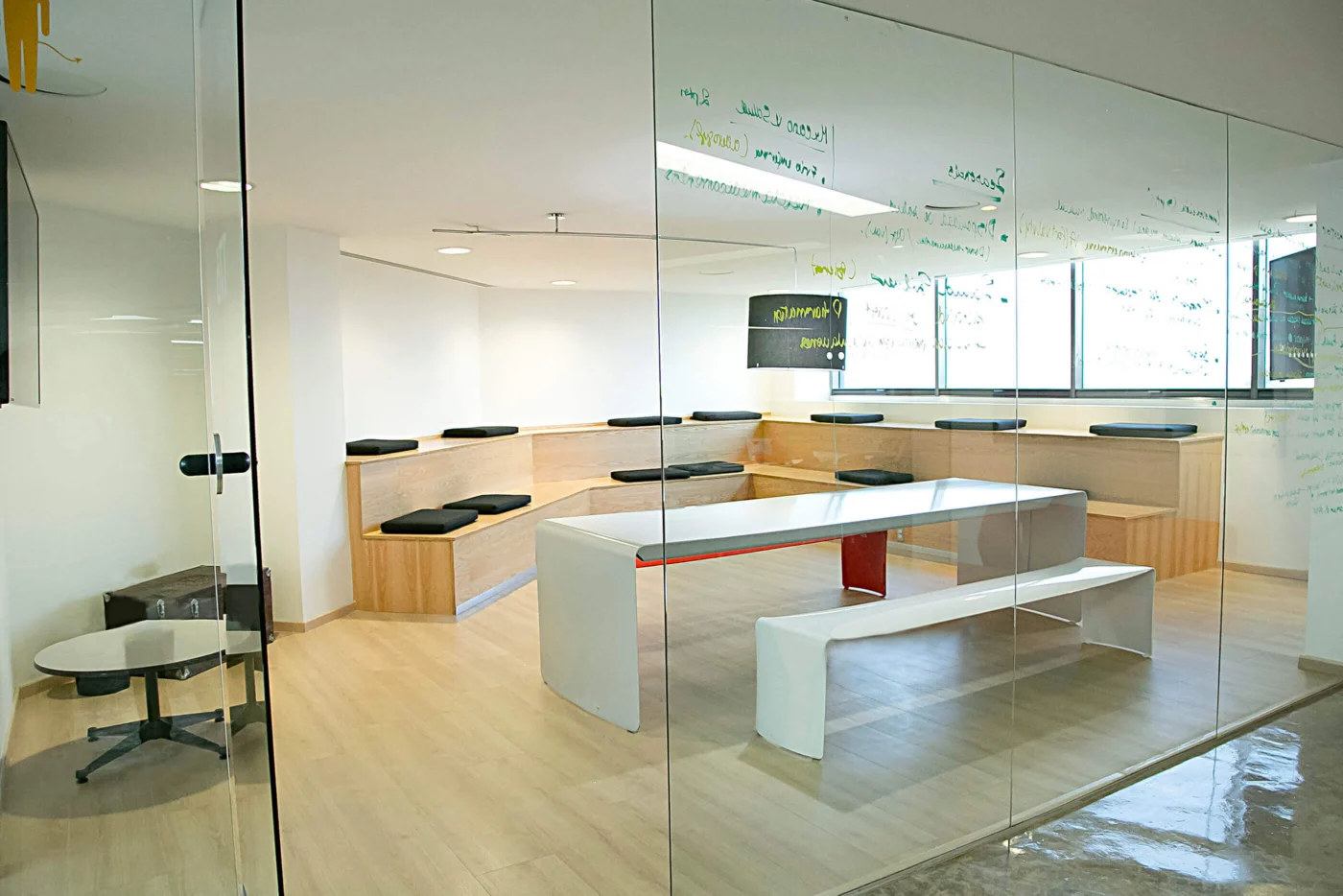 Modern collaborative workspace in Weber Shandwick Mexico City office with tiered seating, whiteboard walls and meeting table