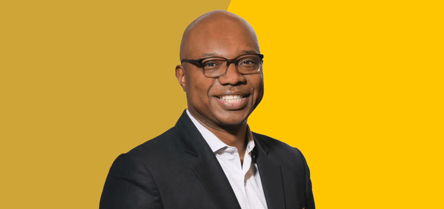 Errol Cockfield, North America Crisis & Issues Practice lead at Weber Shandwick, professional portrait against a yellow background