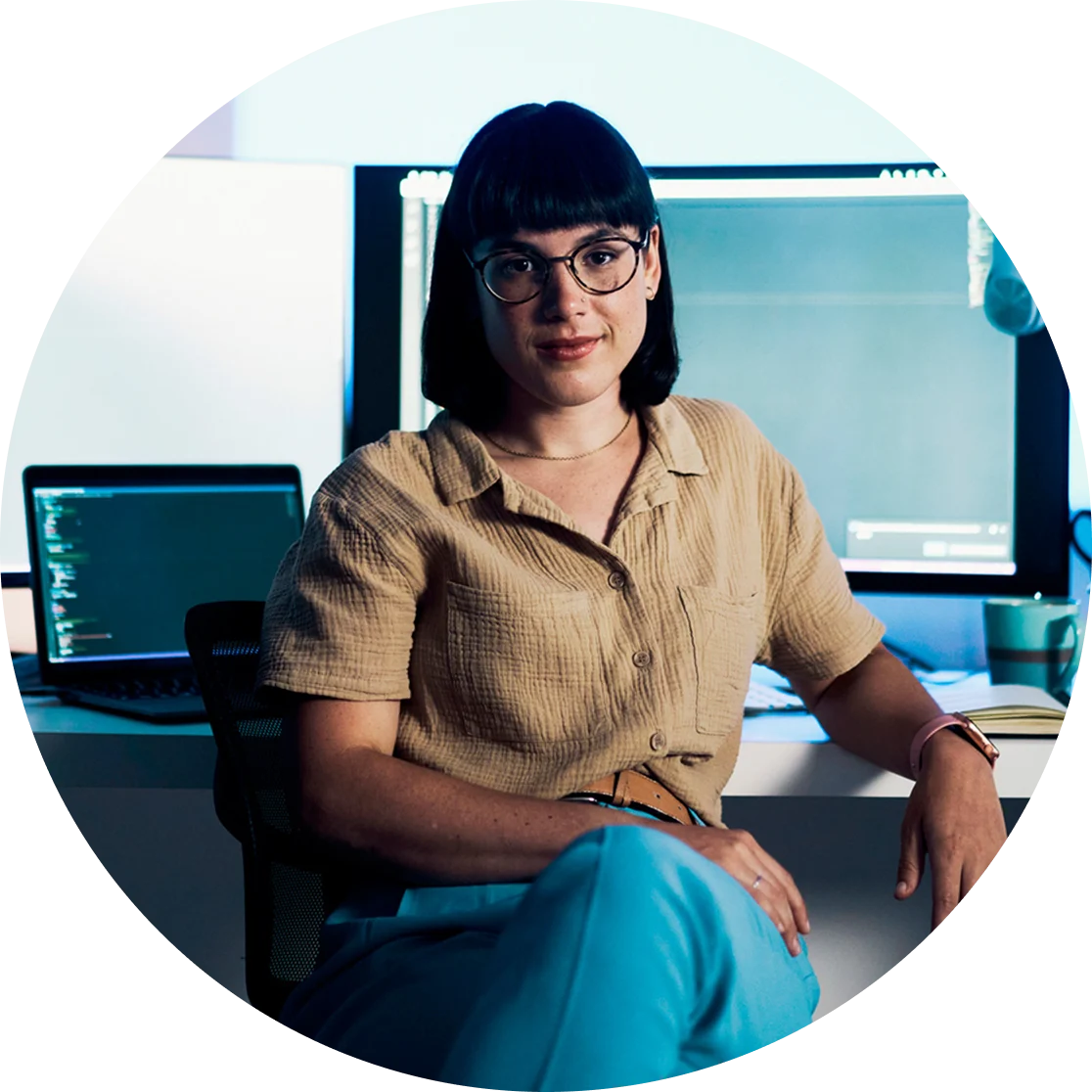 Weber Shandwick team member working at computer with code and data screens, representing AI and technical expertise behind HALO platform