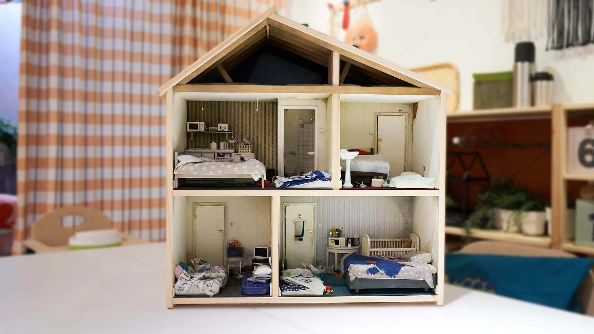 Dollhouse interior showing cramped and unsuitable living conditions to highlight child housing crisis in IKEA campaign