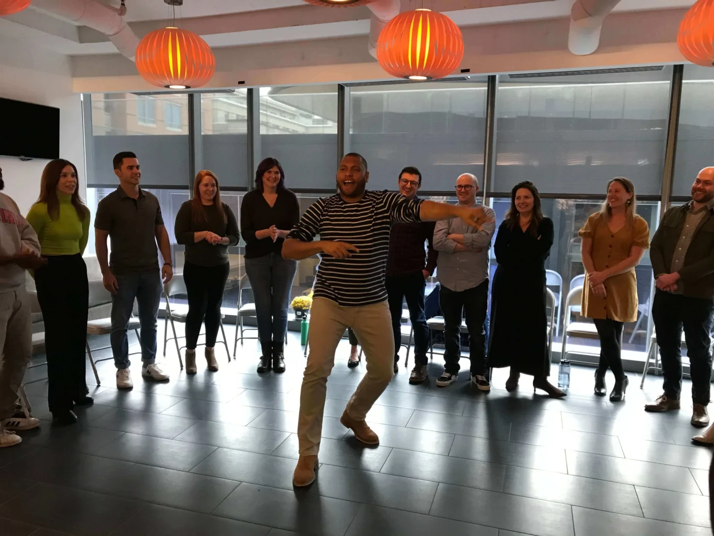 Weber Shandwick Washington DC team gathering in office space, showcasing team culture and employee engagement during group activity