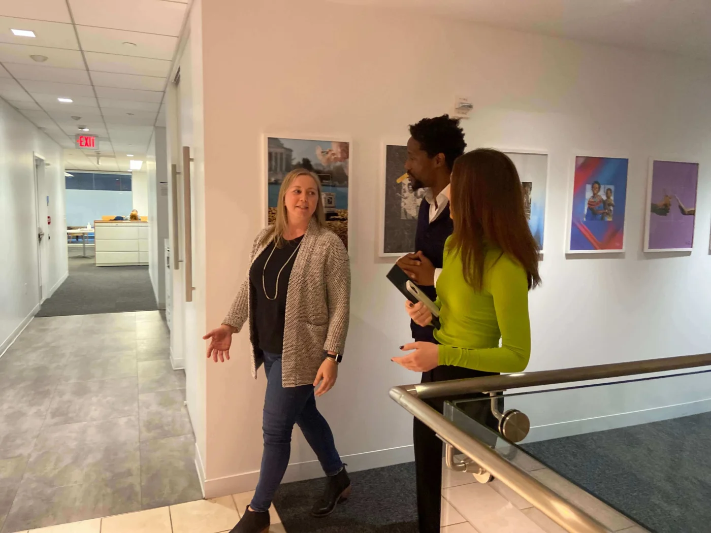 Weber Shandwick Washington DC colleagues walking and collaborating in office hallway, reflecting team culture near White House location