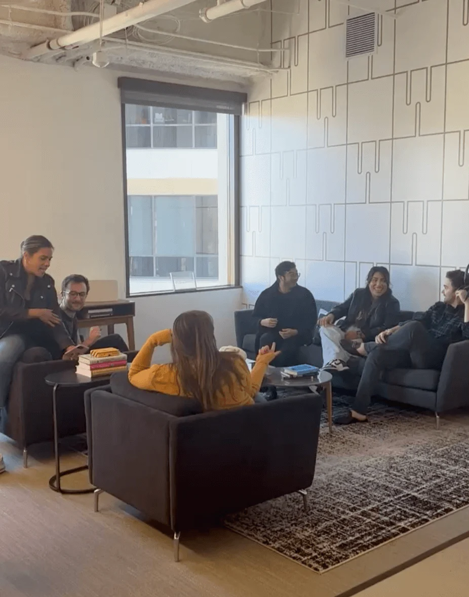 Weber Shandwick Los Angeles team members collaborating in lounge area, highlighting relaxed workspace and team culture in California office