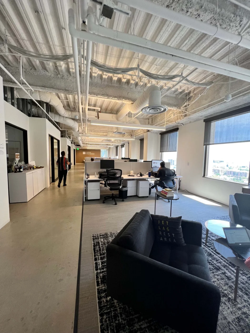Weber Shandwick Los Angeles office open workspace with desks and lounge seating, showcasing modern collaborative environment in California