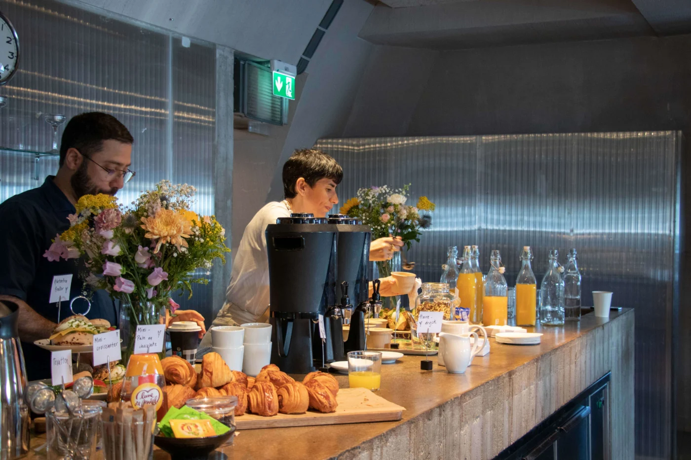 Prime Stockholm office breakfast setup with pastries, drinks and flowers, reflecting creative workspace culture at Slussplan location