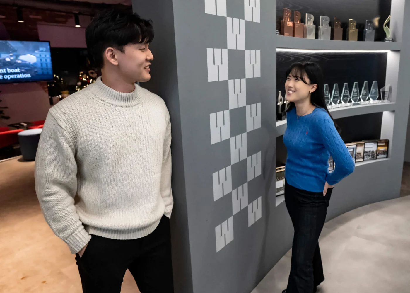 Weber Shandwick team members in Seoul office collaborating near display wall, highlighting modern workspace in Gangnam district Korea