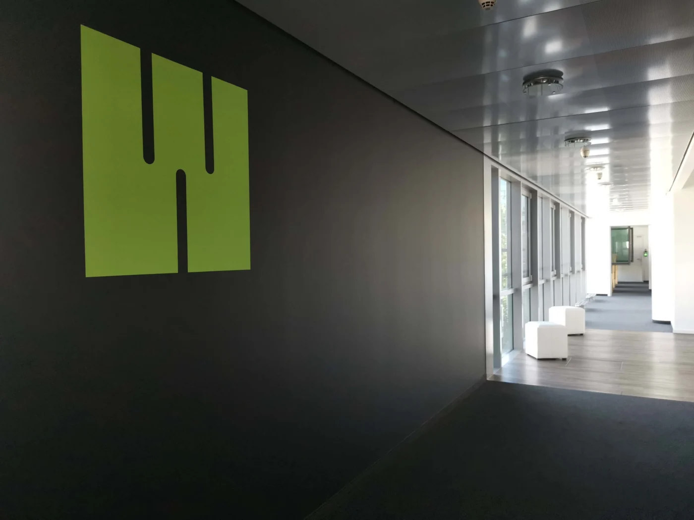 Weber Shandwick Munich office corridor with branded wall and modern workspace design reflecting global communications environment